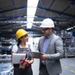 manager supervisor worker discussing about production results new strategy factory industrial hall 1